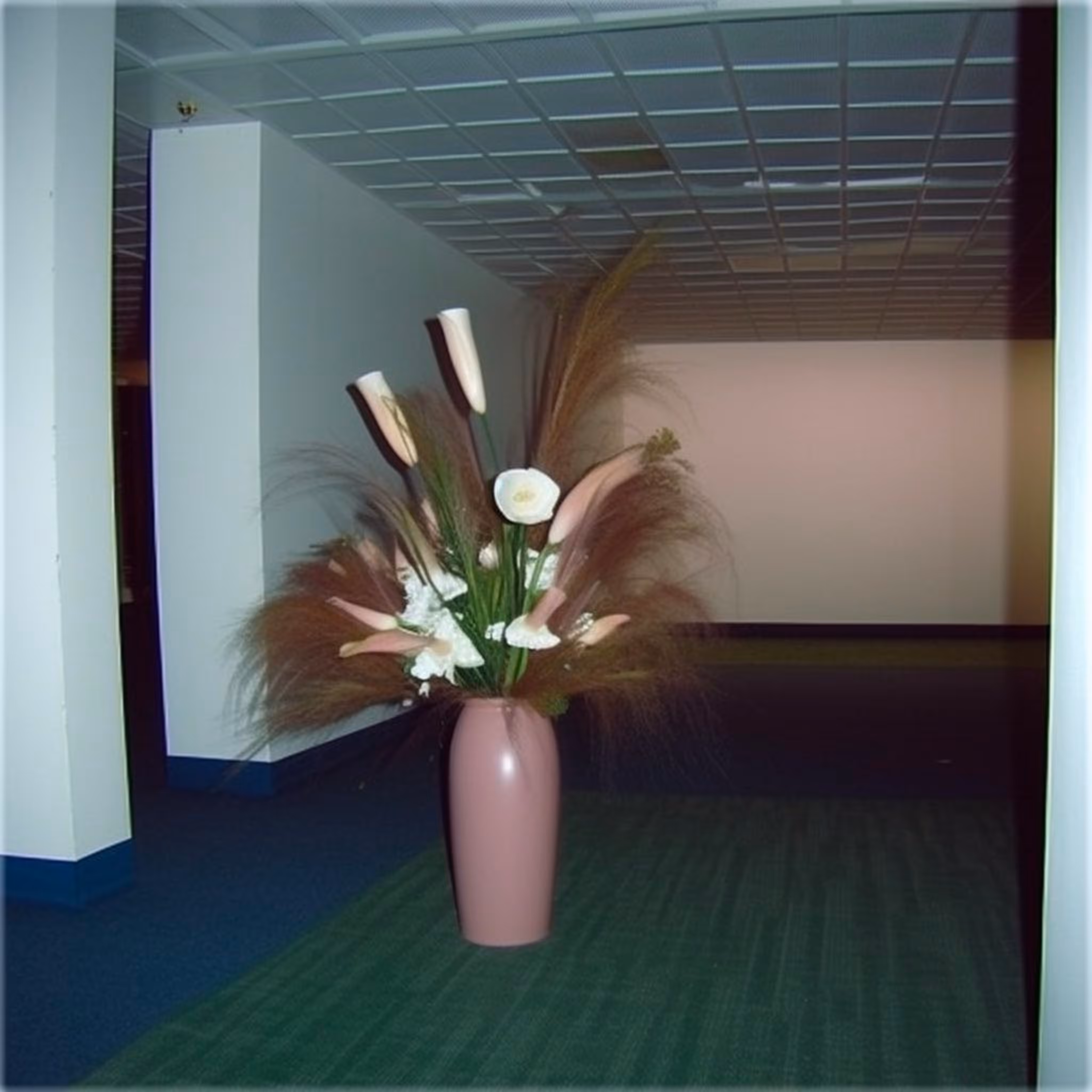 A Pink Vase Holding A Beachy Flower Arrangement In The Middle Of An Empty Room On The Third Floor Of A Large Building