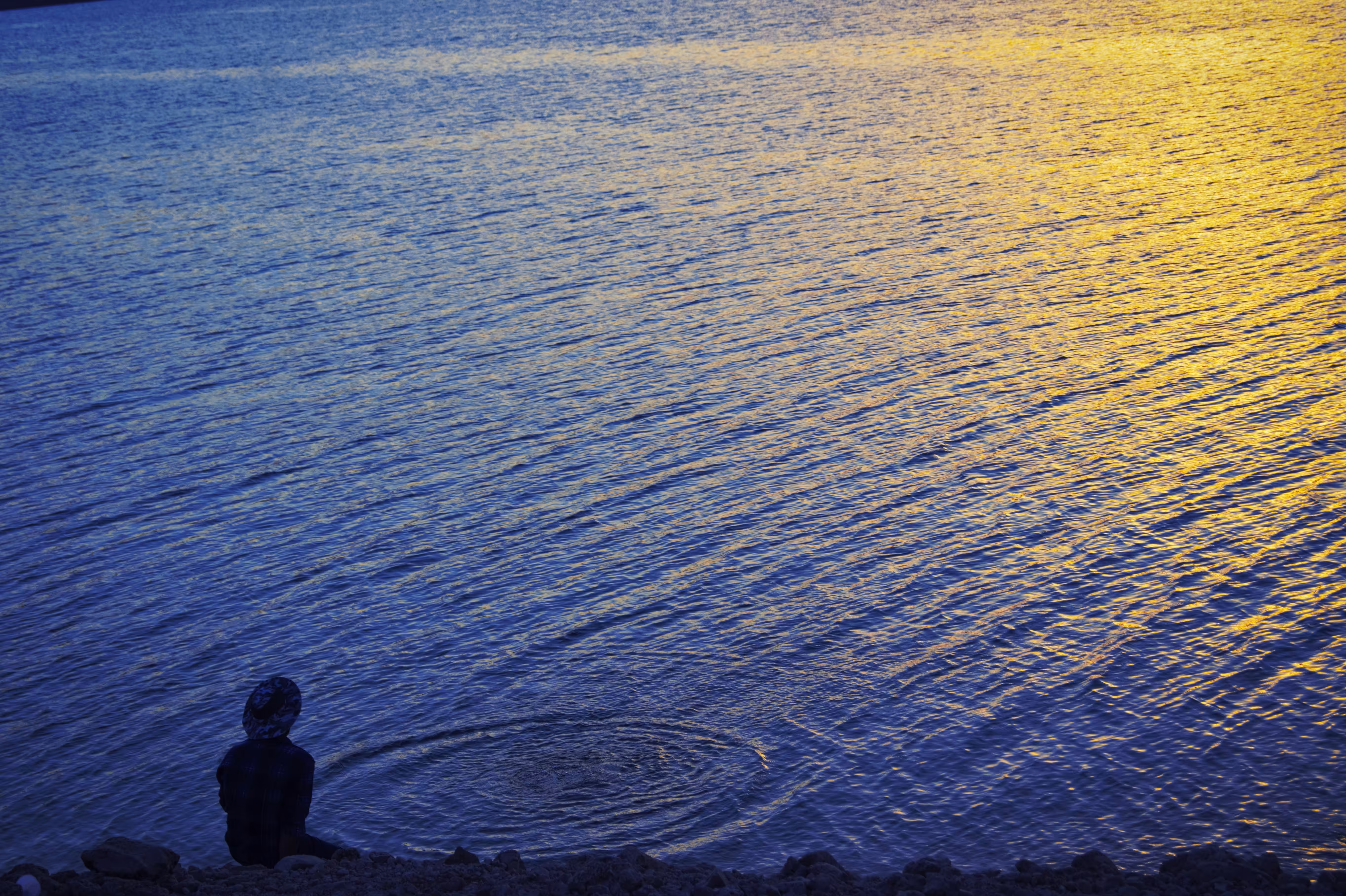 A man on the beach at sunset