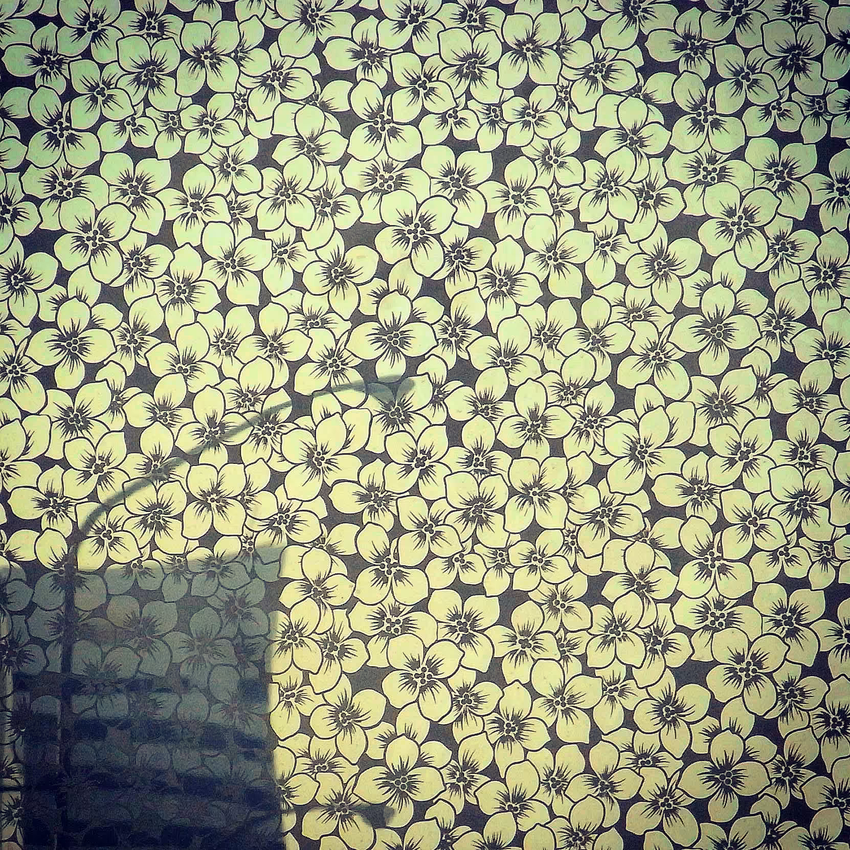 Sakura pattern, as seen in the reflection of a truck before our car, on our way from Kansai Airport to Osaka