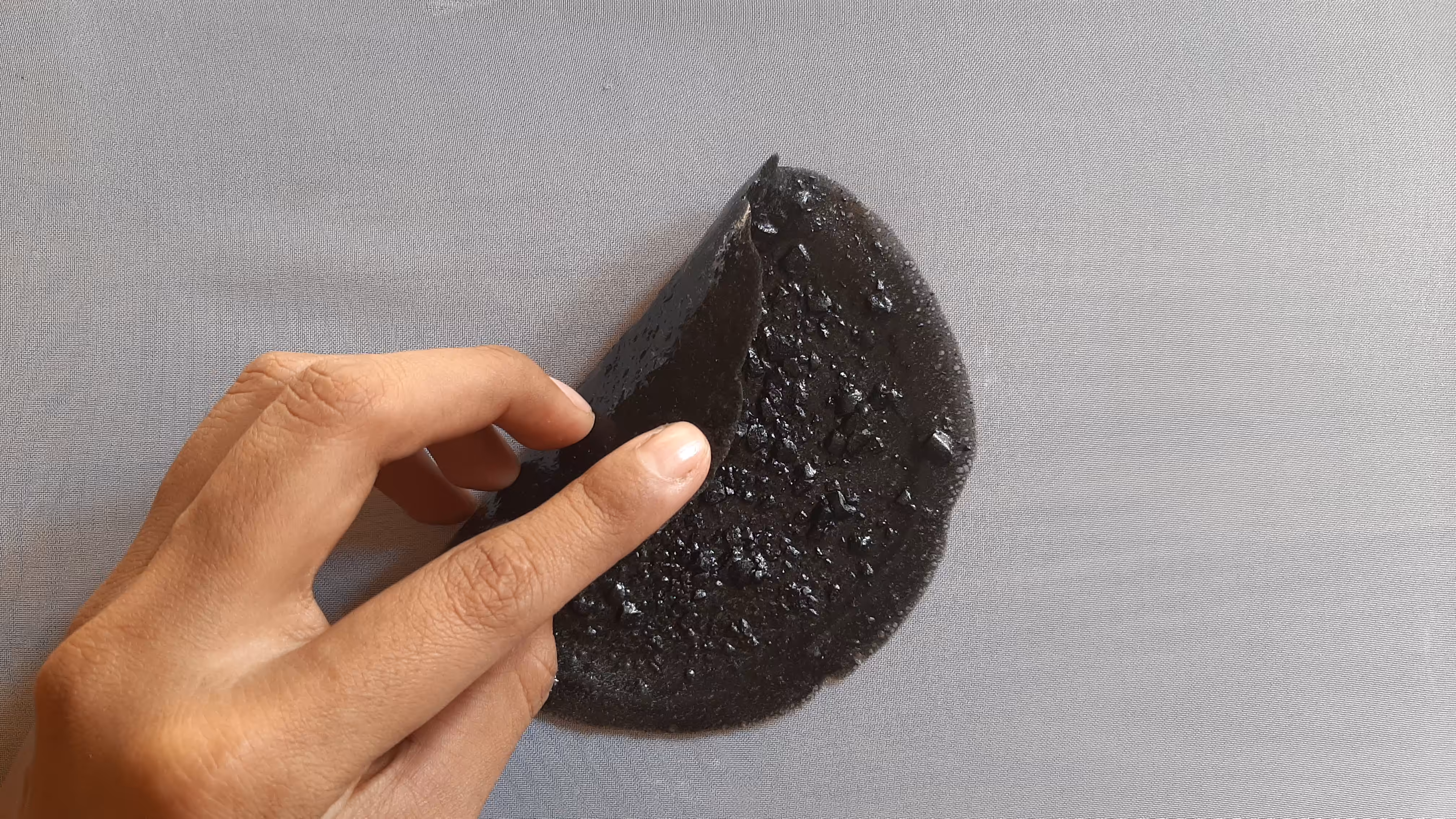 Circular shape being folded by my hand