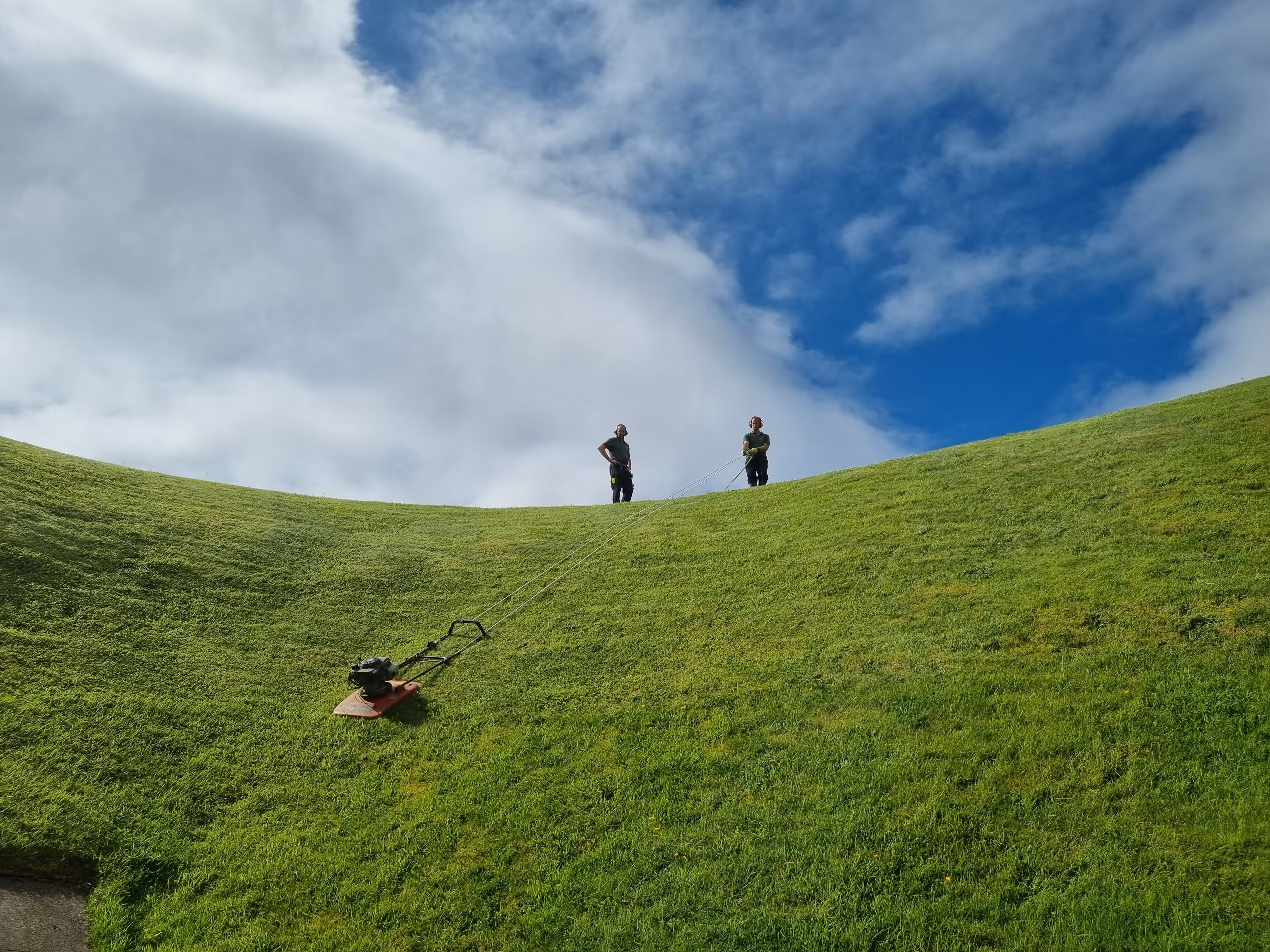 Mow the grass with a swing in the sky