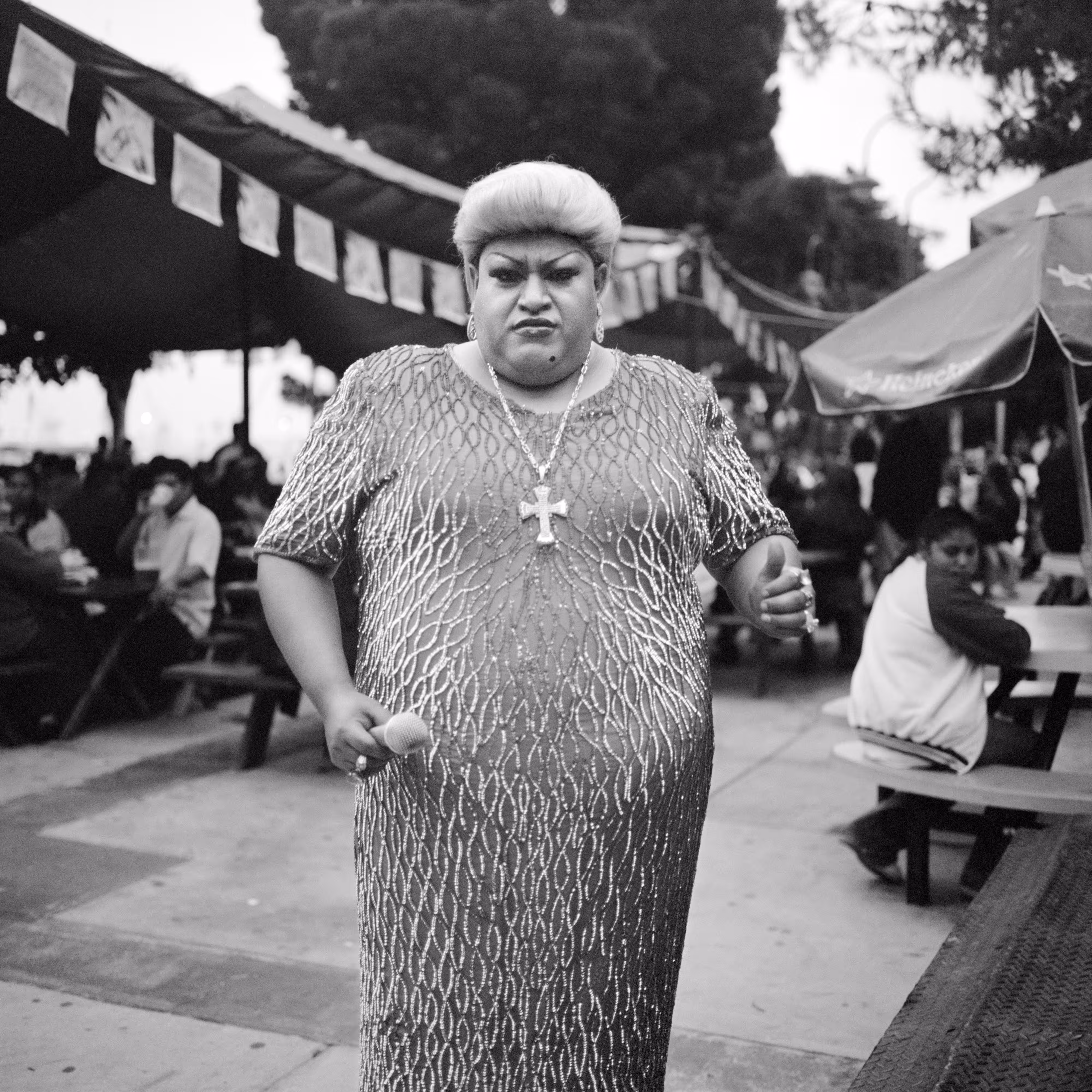 THE VILLAGE #20 PERFORMER IN A GOWN WEARING A CROSS by Deanna Templeton