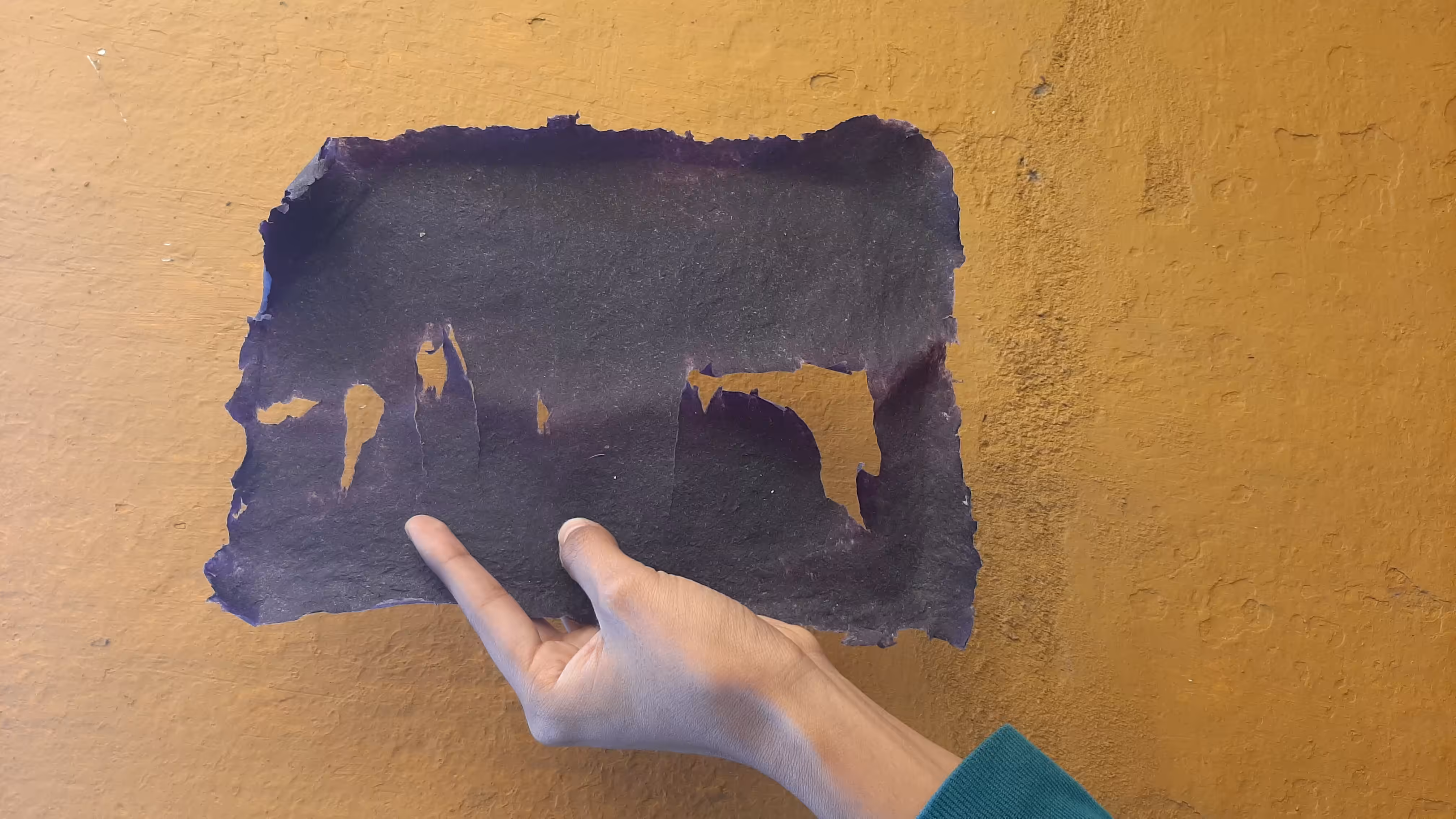 Irregular Rectangular shape with tears/breaks, held by my hand