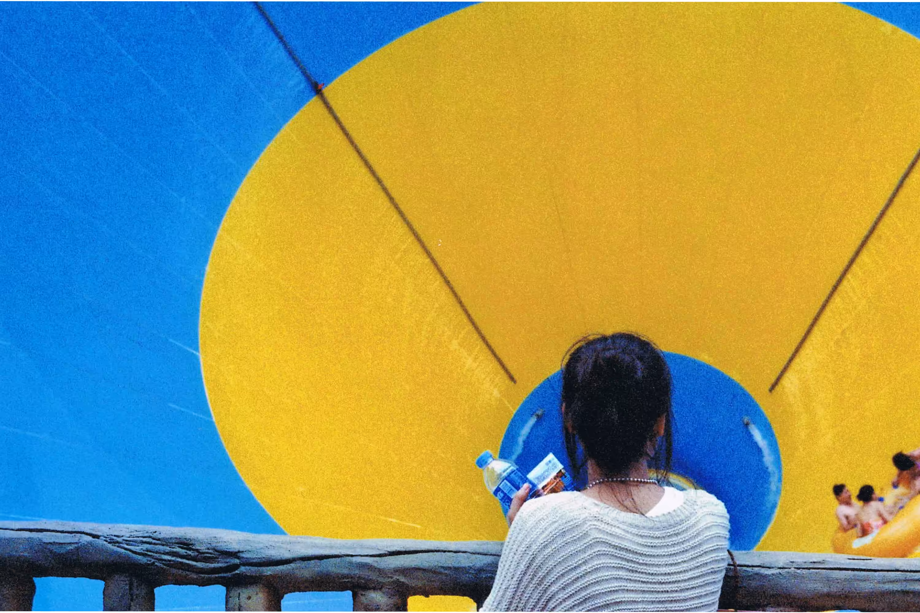 girl looking down a joy ride in a theme park
