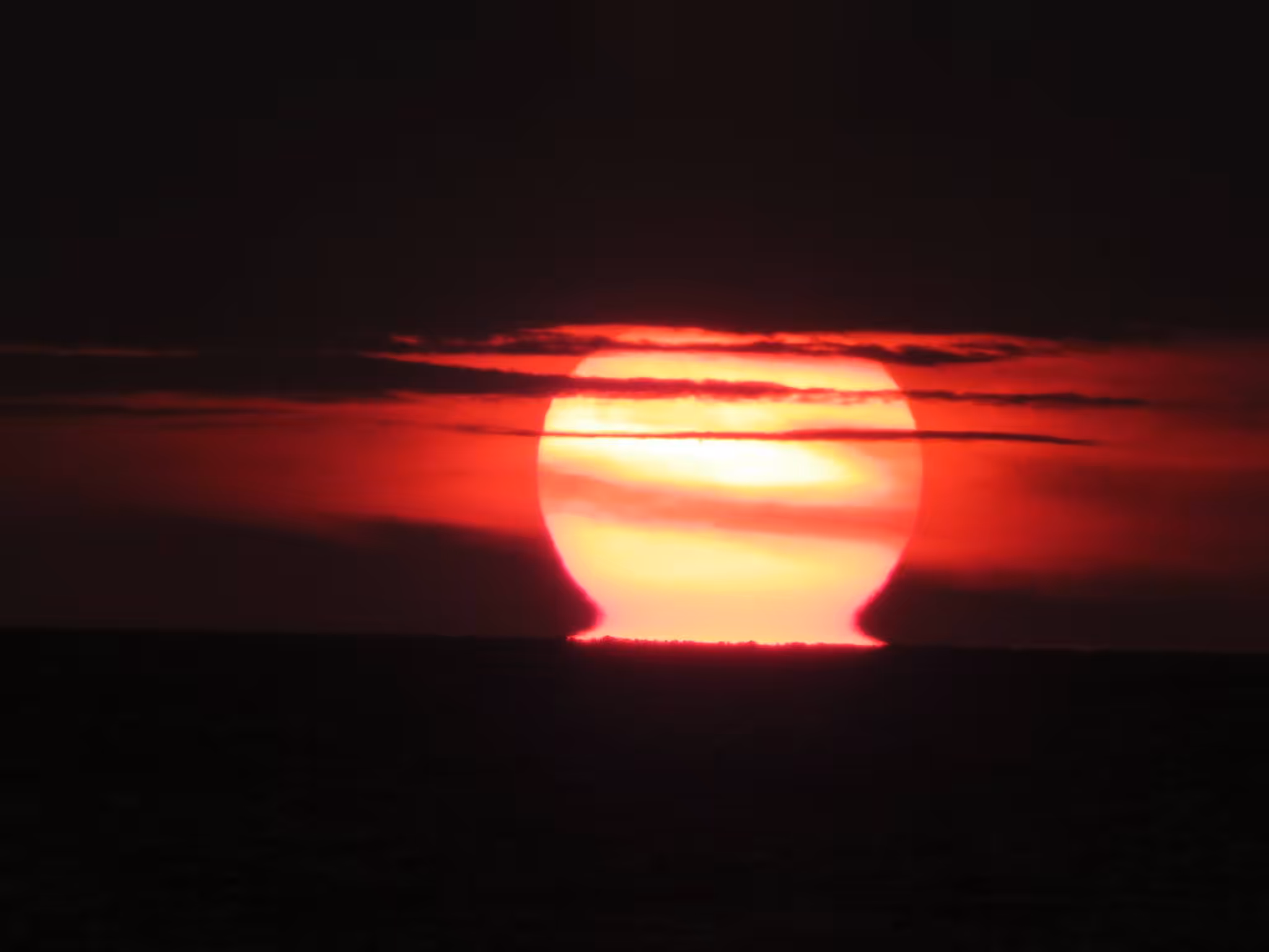 Sun Melting into the Ocean