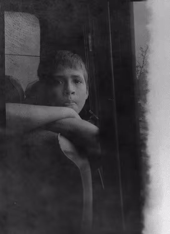 Some kid captured in a bus.