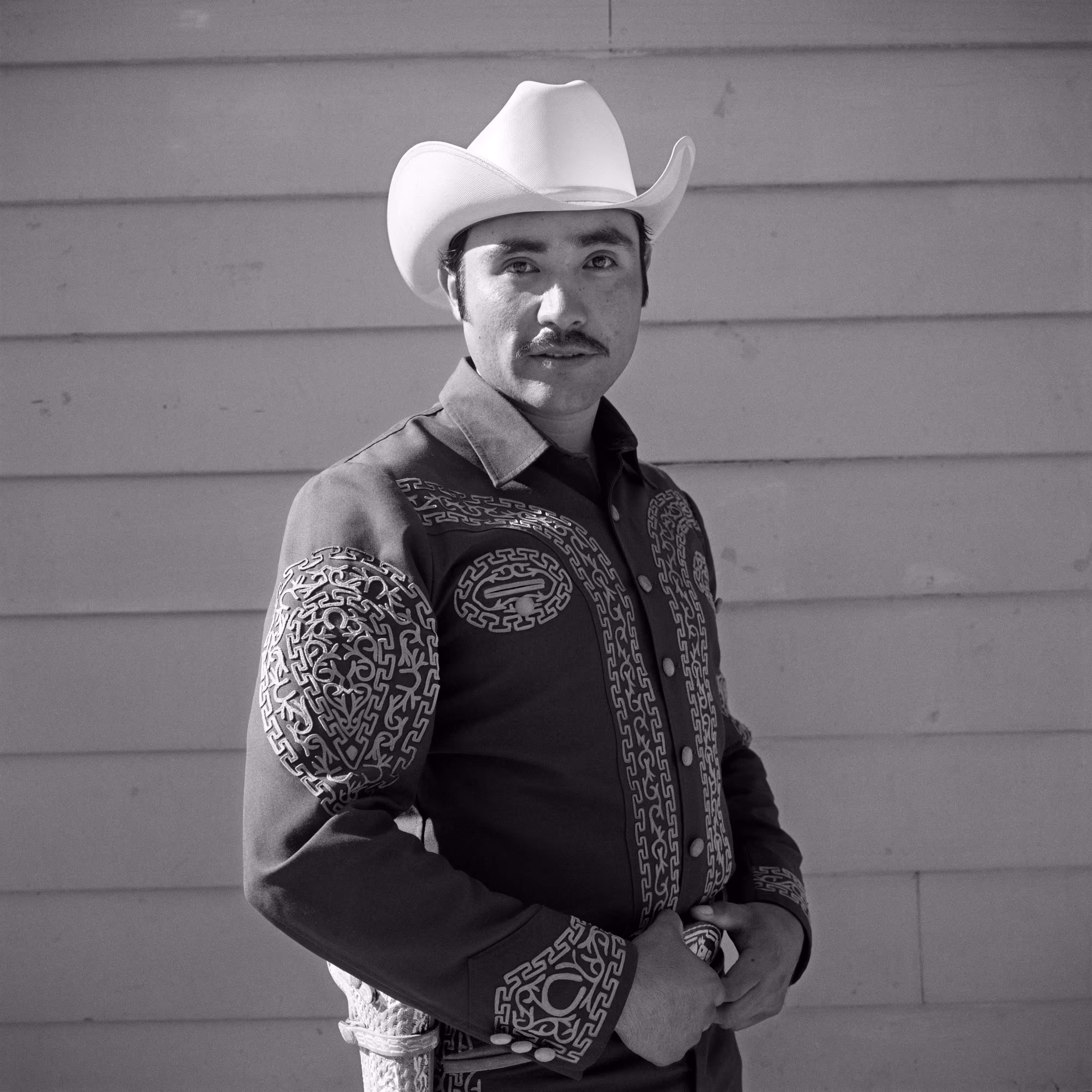 THE VILLAGE #22 PORTRAIT OF A MAN IN A COWBOY HAT by Deanna Templeton