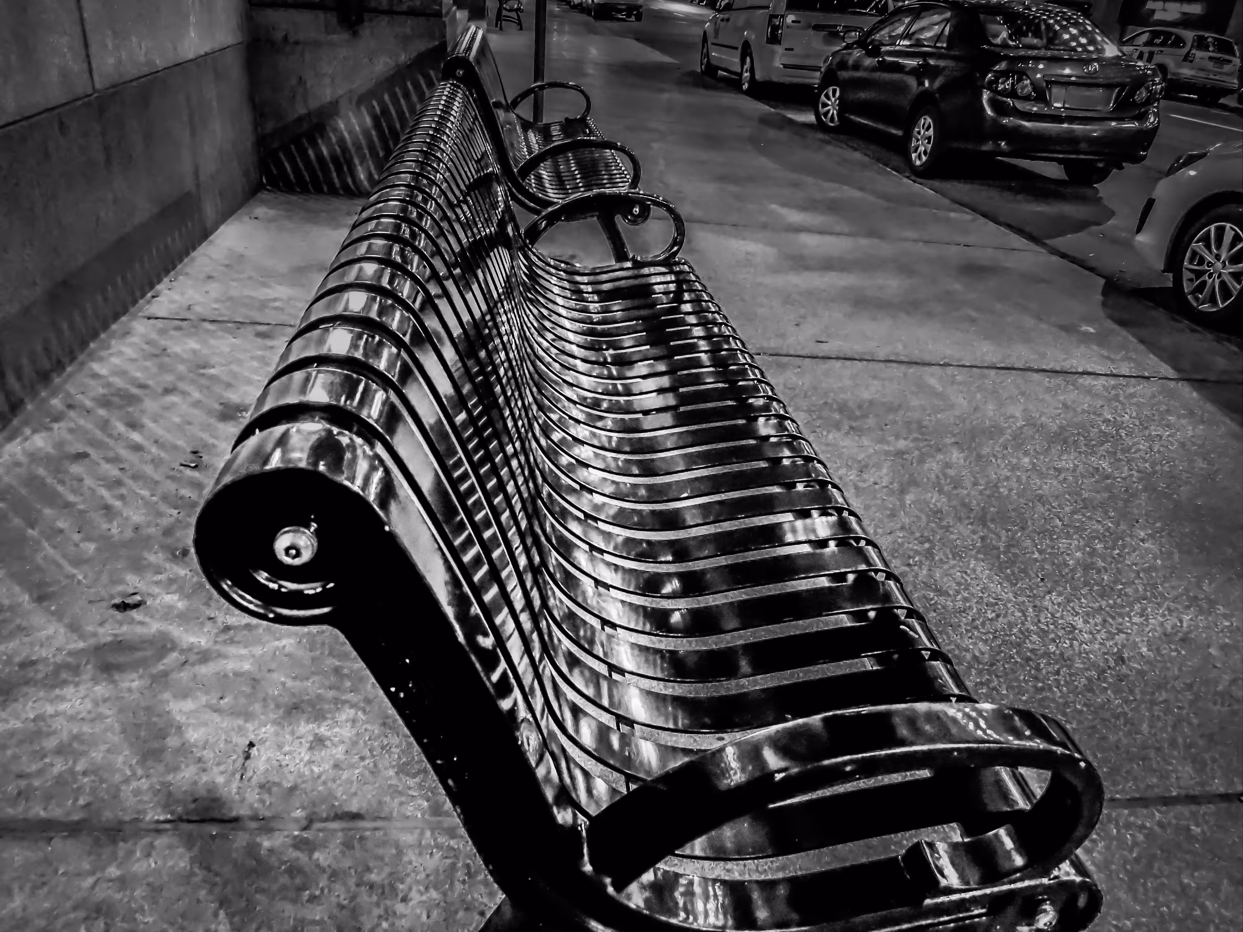 The bench on the sidewalk.