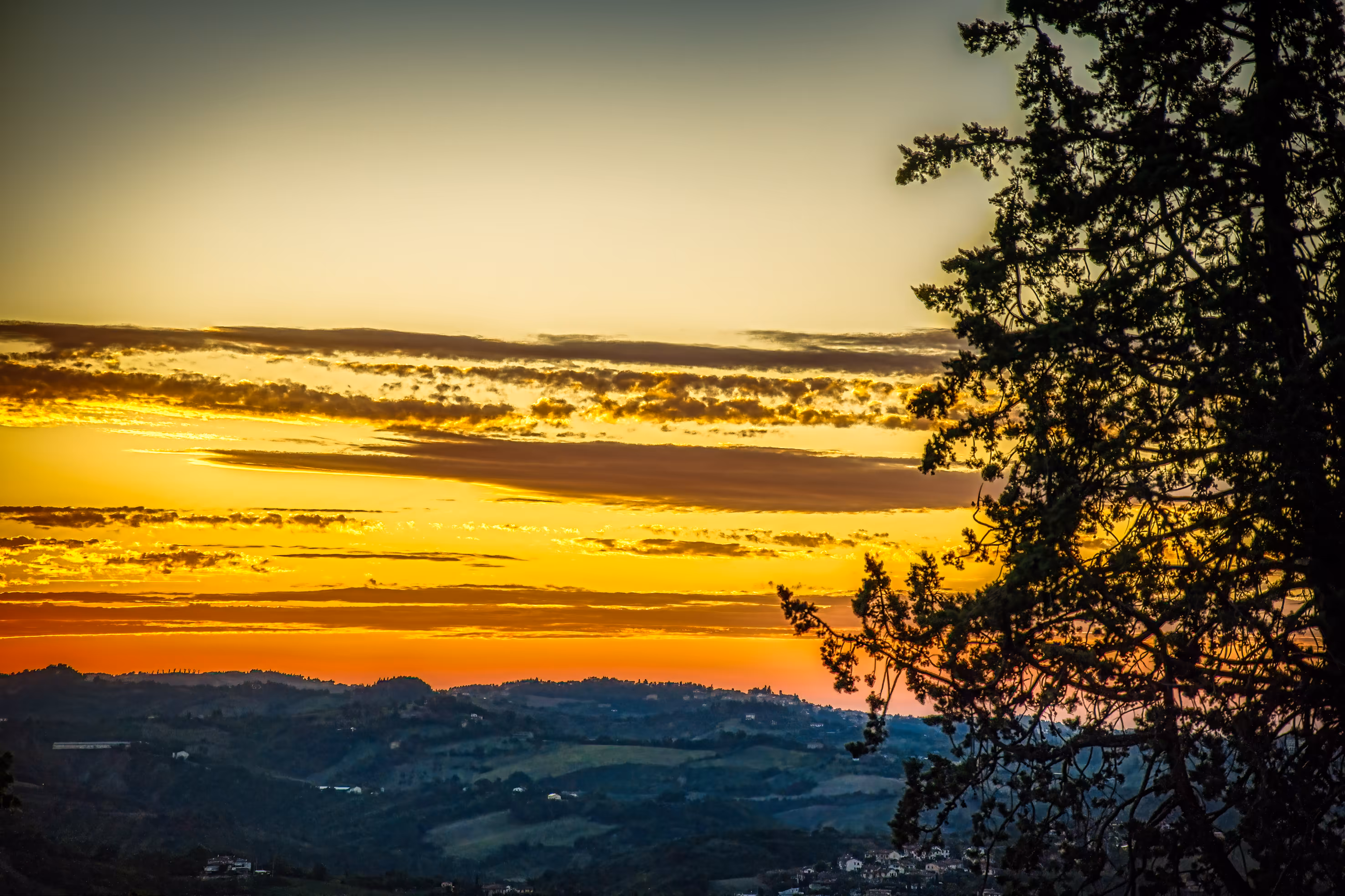 Sunsets and Sunrises: Golden Horizon Framed by Nature – Sunset Over Verucchio