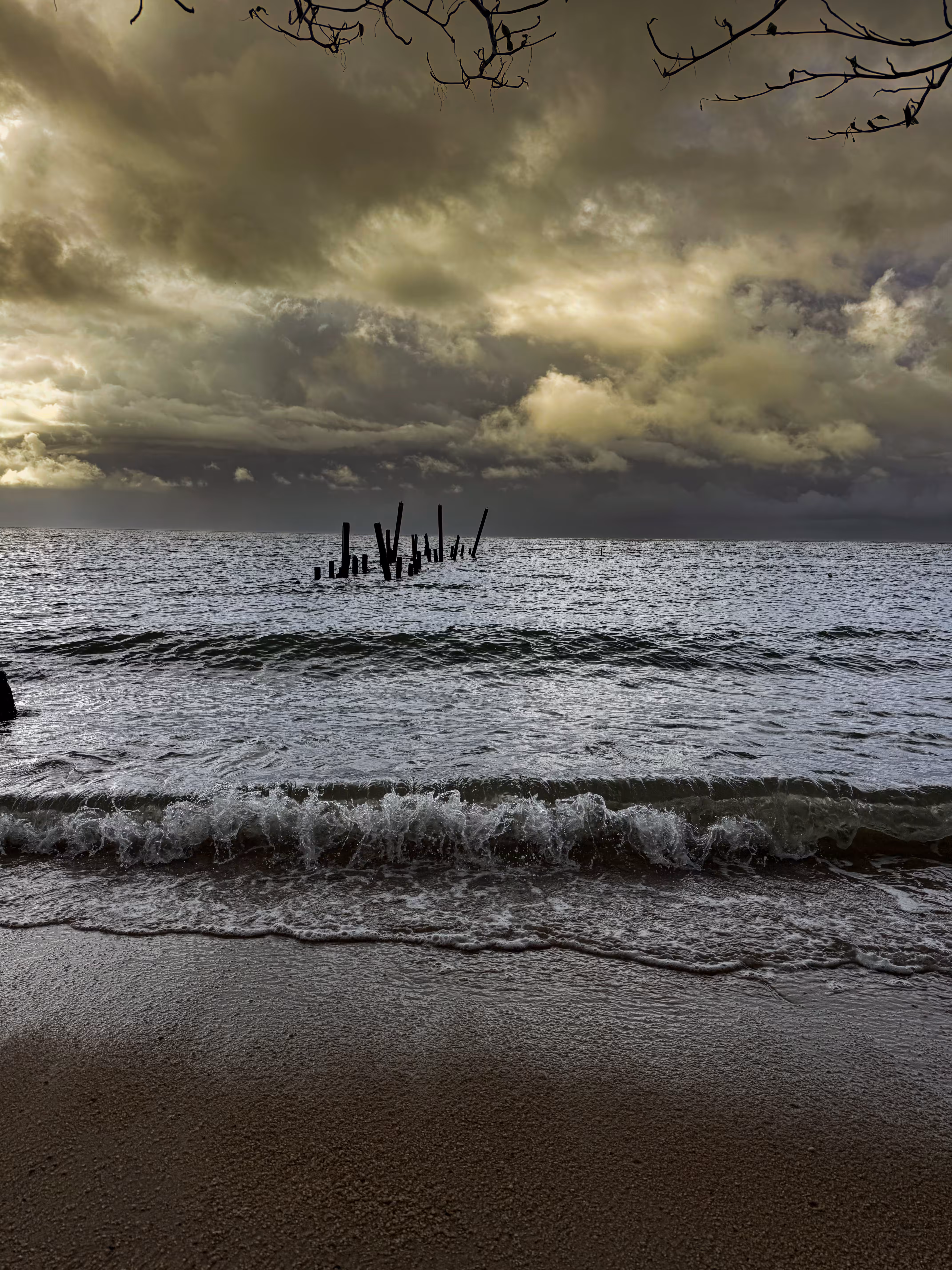 broken pier beneath tempest skies