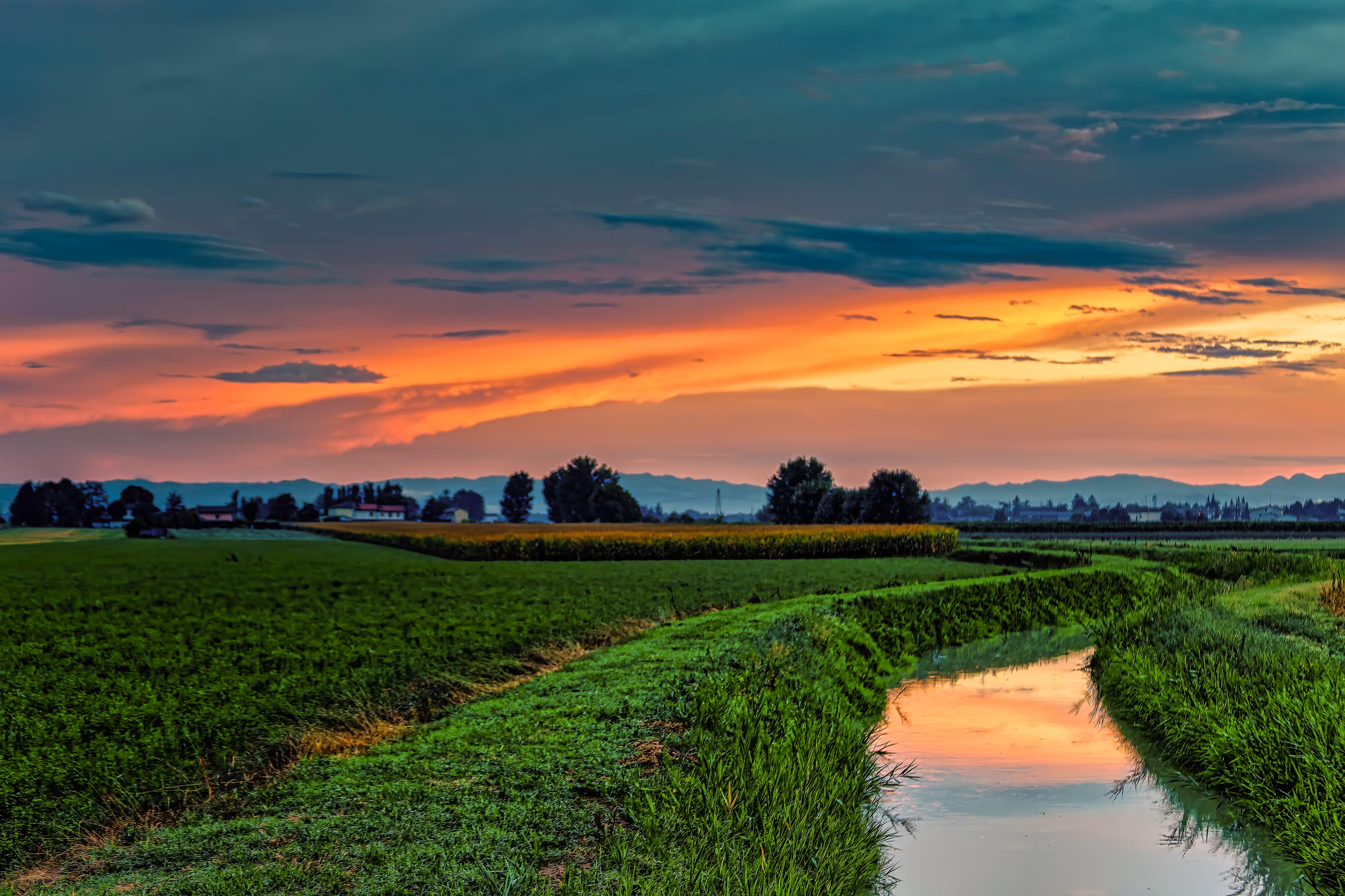 Sunsets and Sunrises: Canal in the Romagna Countryside – Reflections of a Summer Sunset