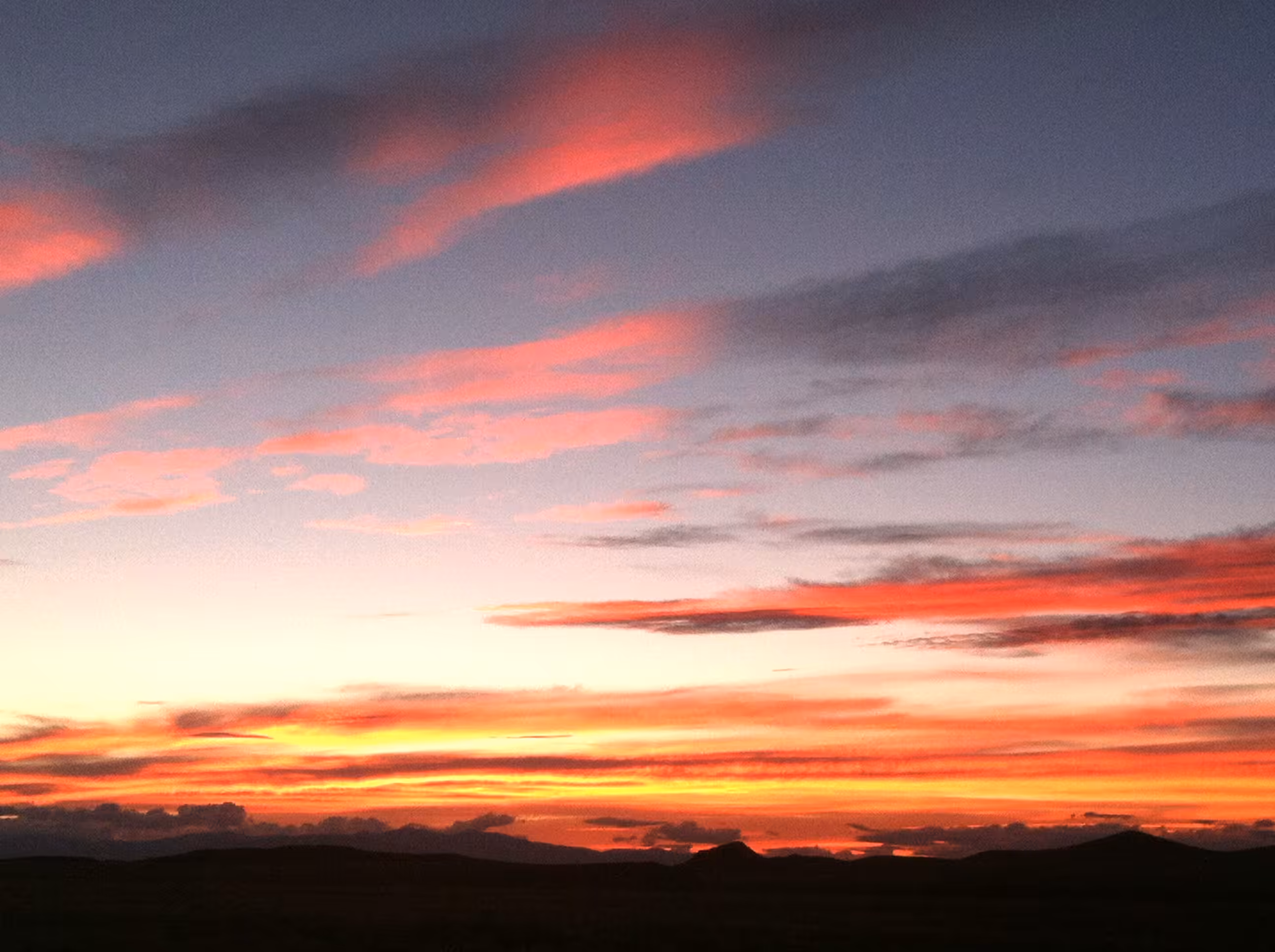 Striking Dusk: Alamosa's Golden and Bold Pink Skies