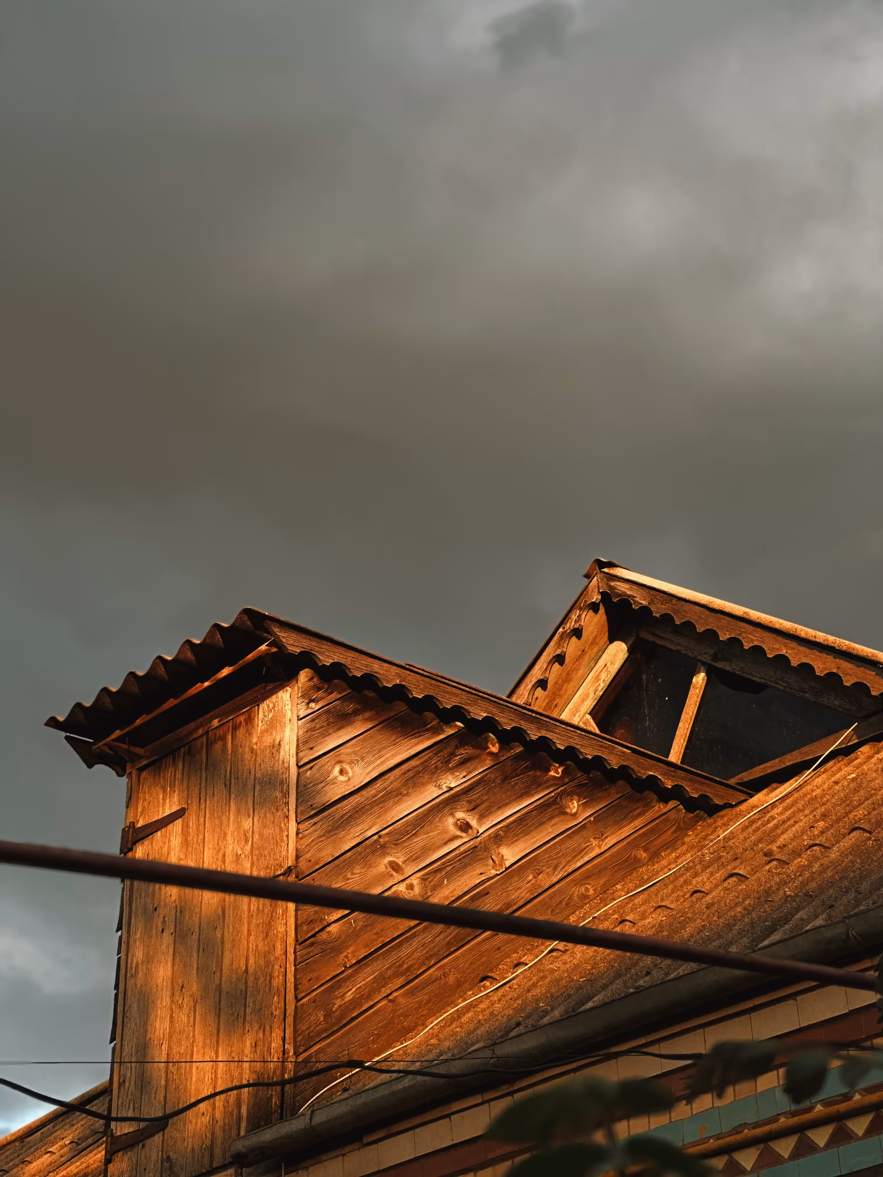 Golden Eaves – Wooden Roof in Evening Light