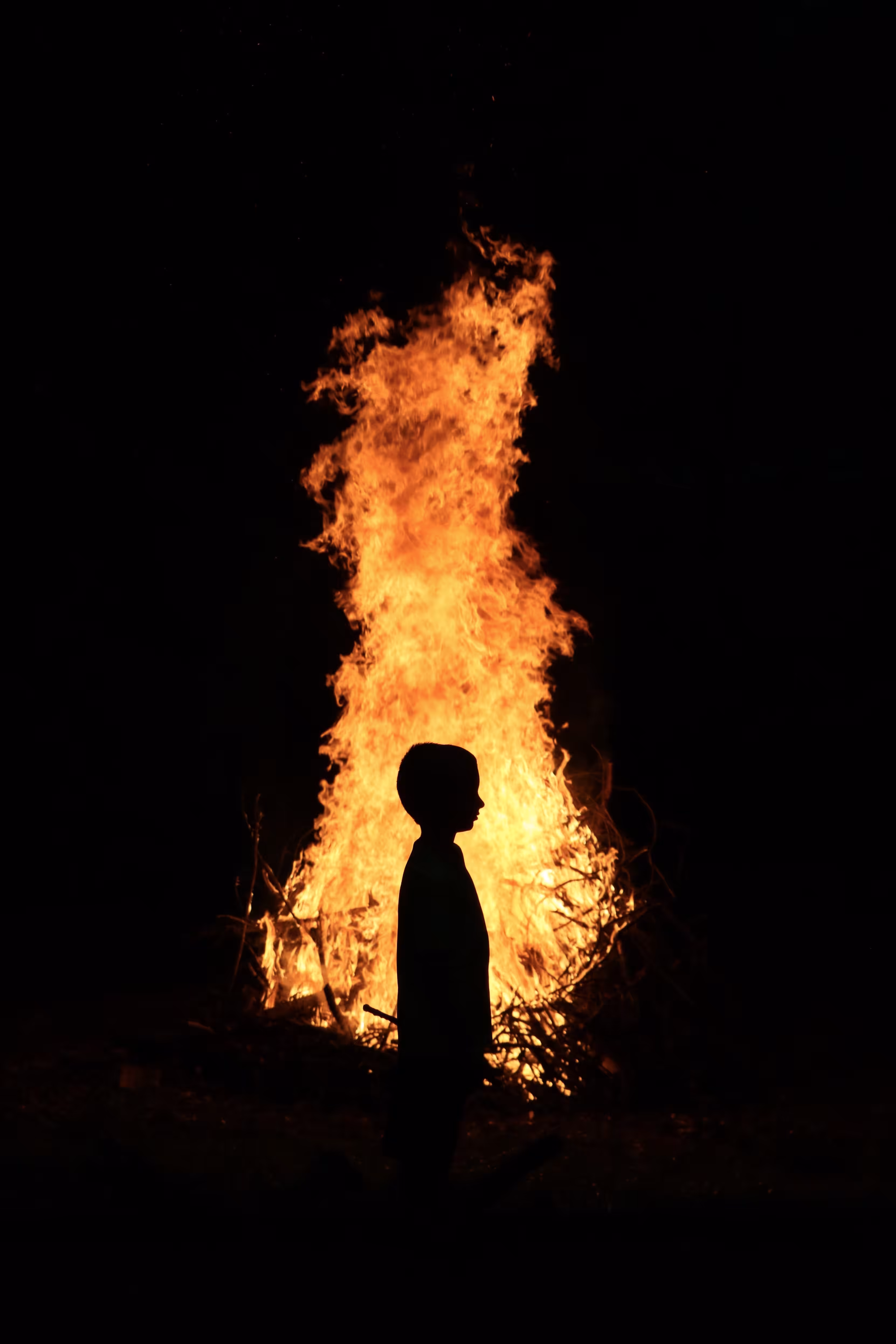 Boy in front of fire