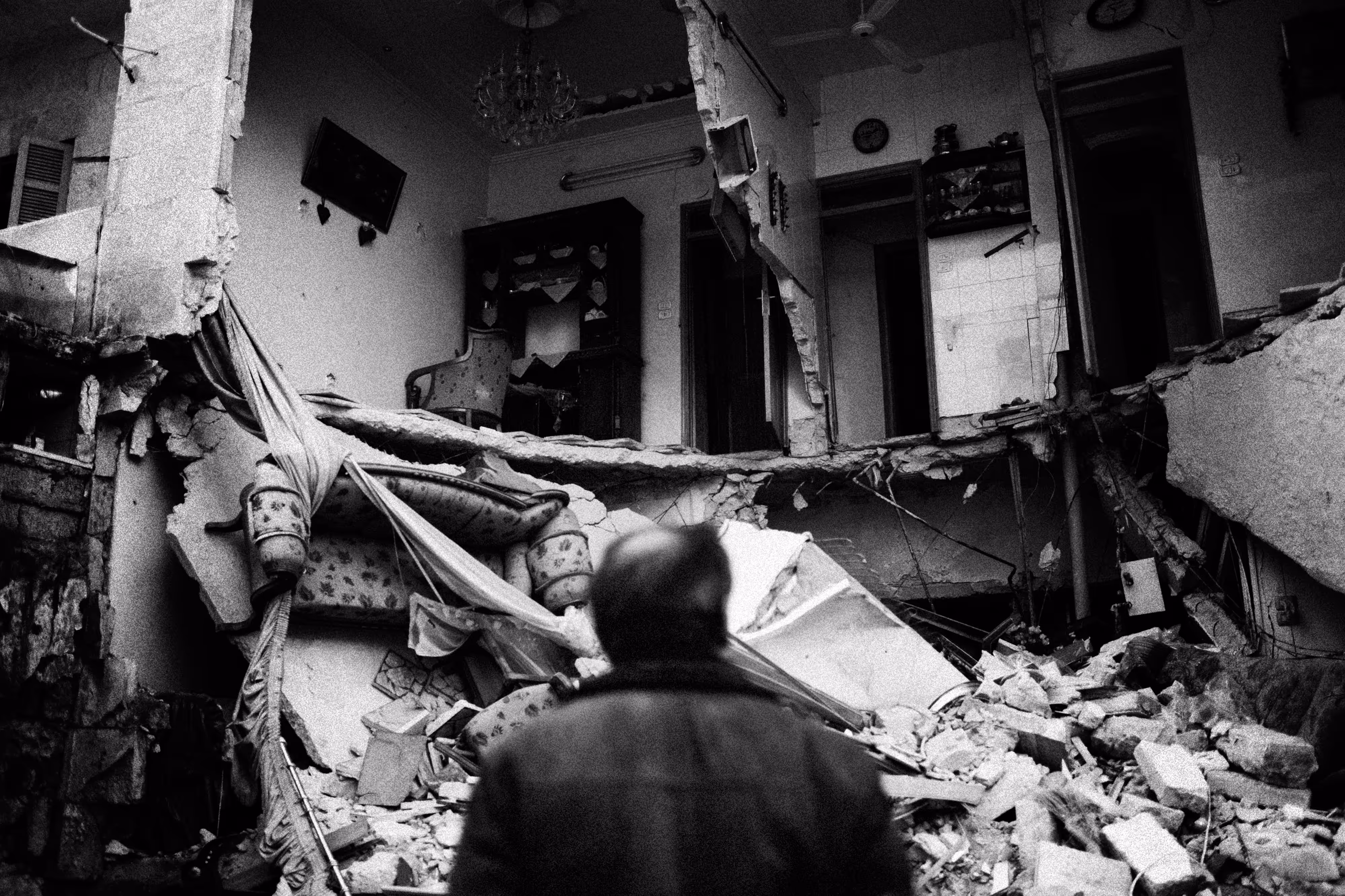 Looking his destroyed home