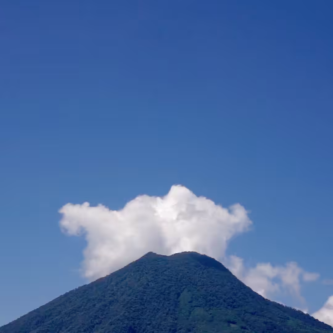 Clouds behind volcano.