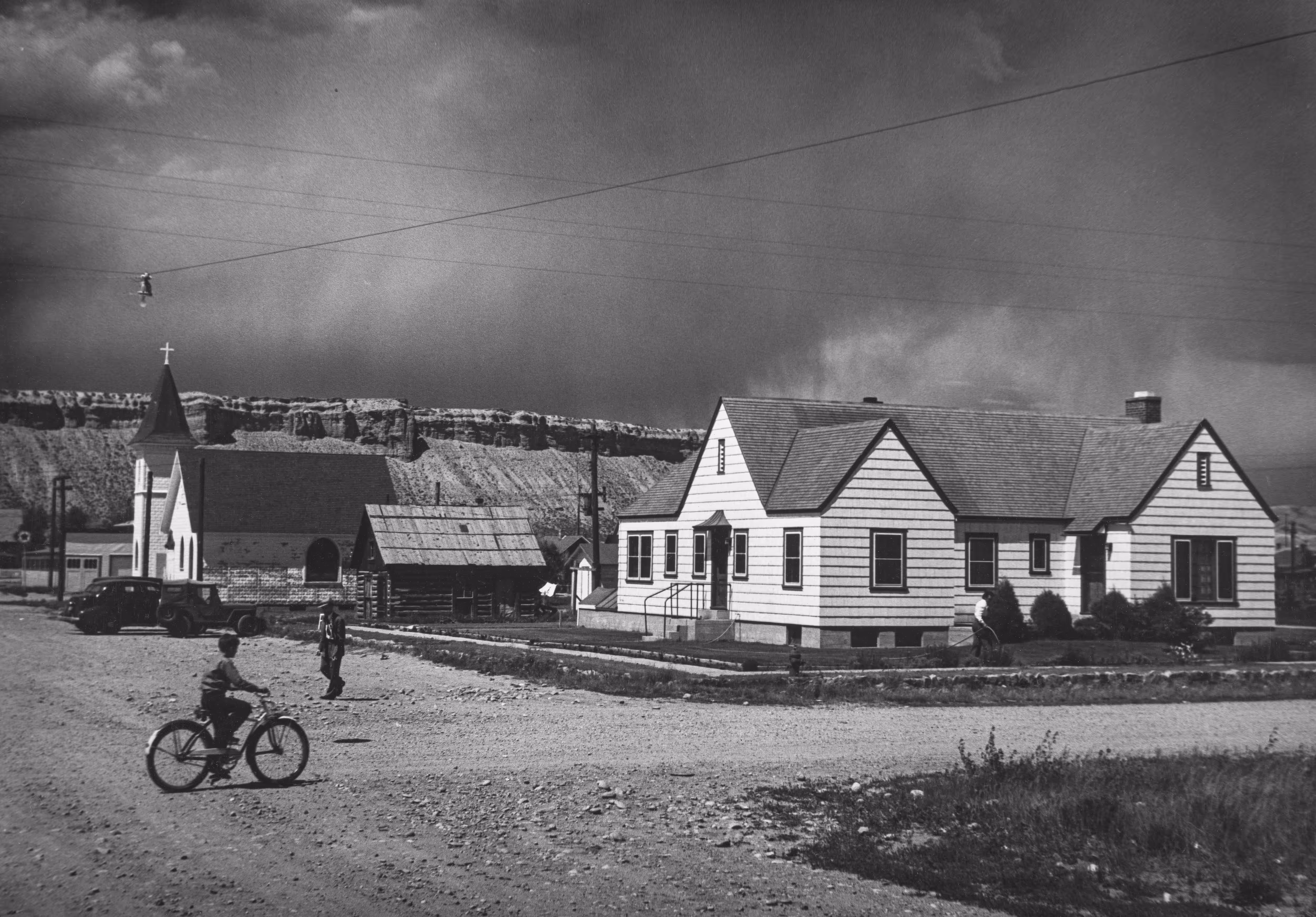 Country Doctor - Hospital in Kremmling, Colorado, Next to Church and Boy on Bicycle