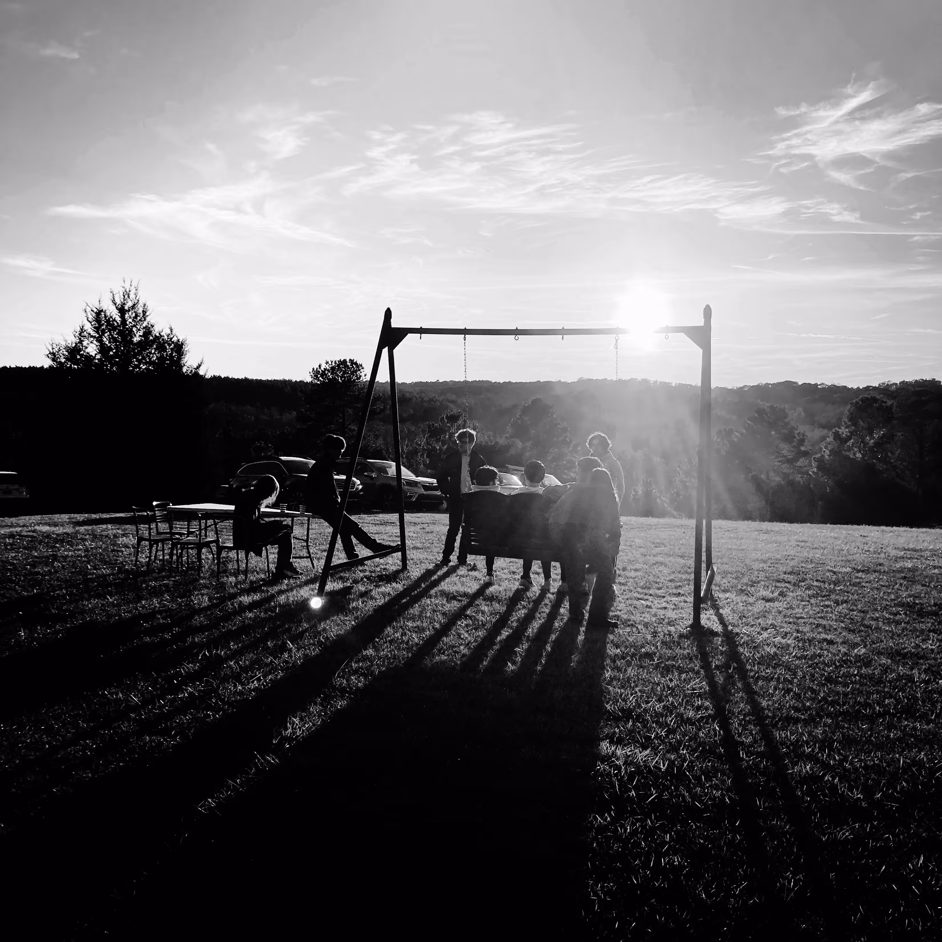 A Group of Young Crypto Enthusiasts Gathering on a Hilltop at Sunset