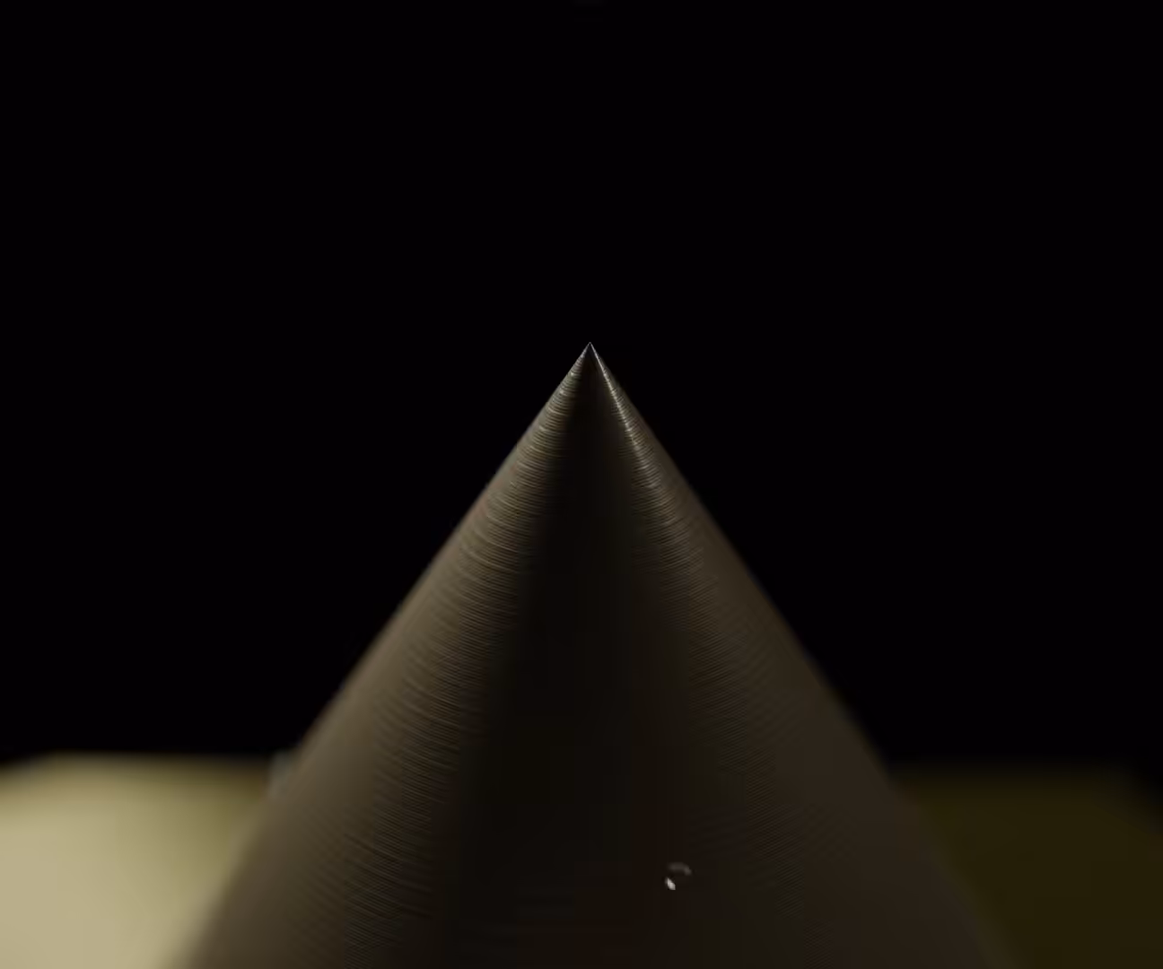 Droplet Falling on a Sharp Point
