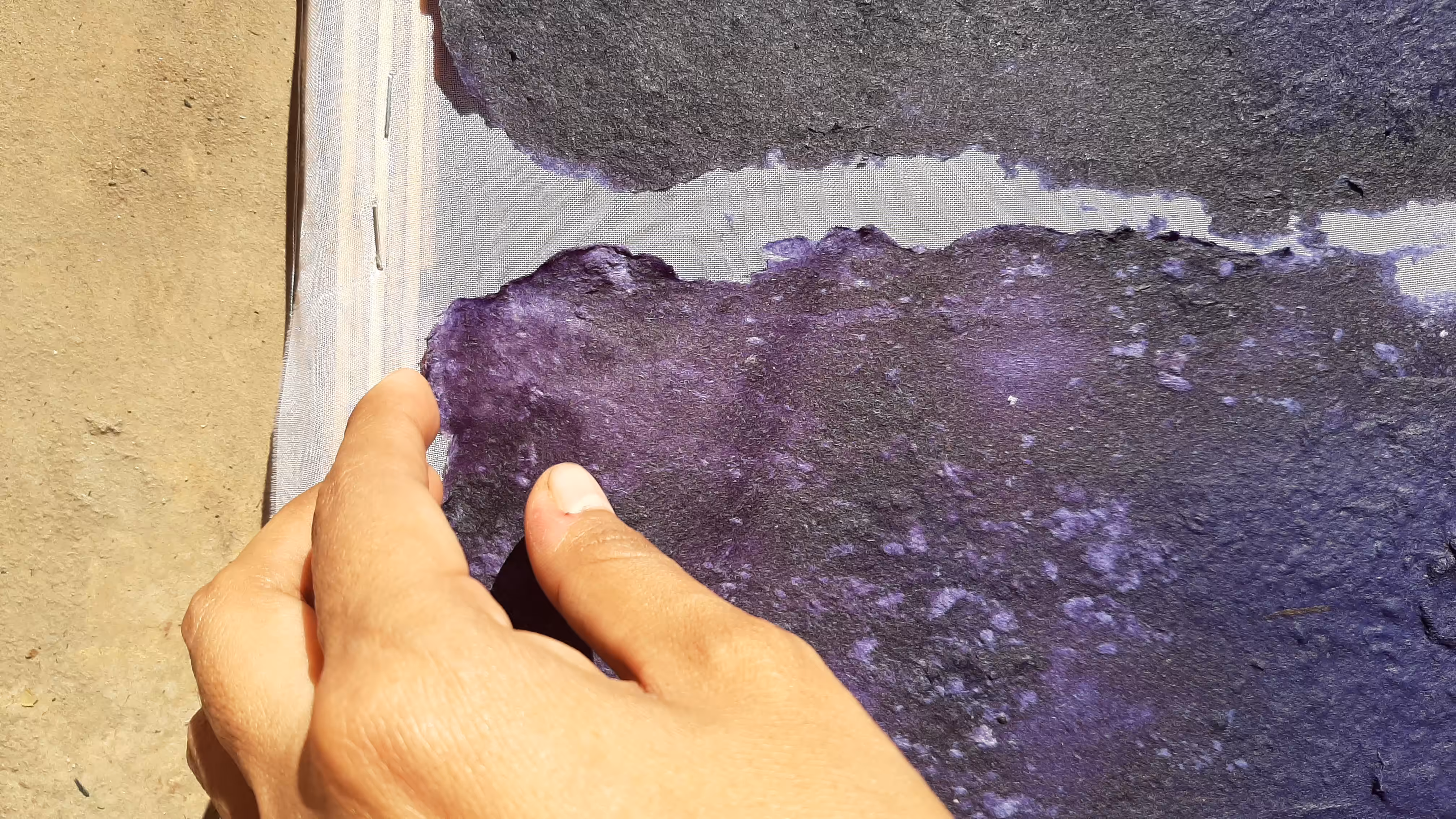 Approaching my hand to peel off the biomaterial