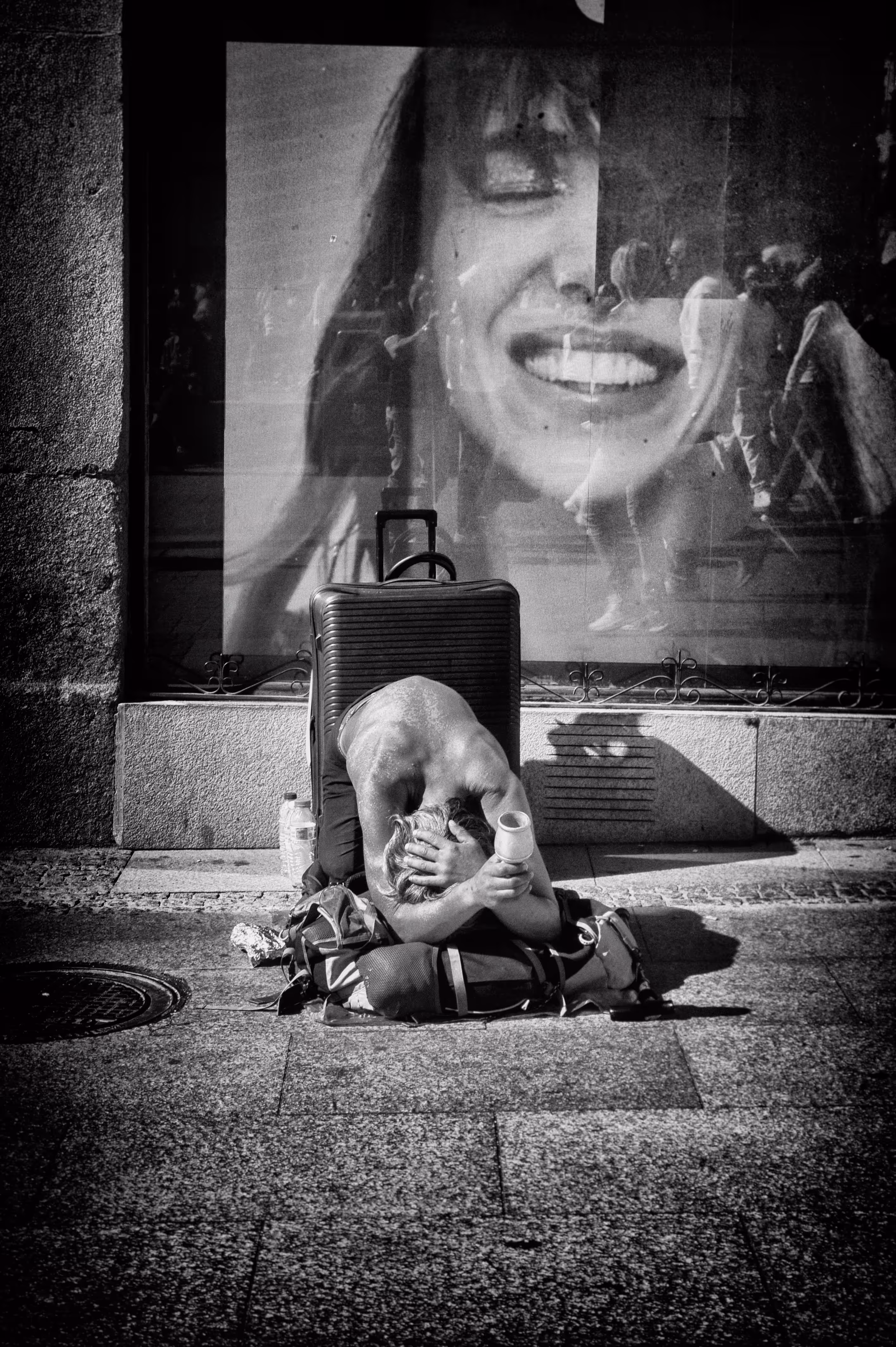 Shop-window smile, street-corner shadow